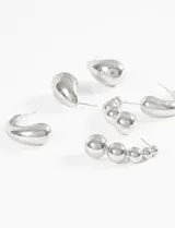 Set de aros plateados con diferentes diseños: aros tipo gota, aros tipo argolla y aros tipo trepadores con esferas.