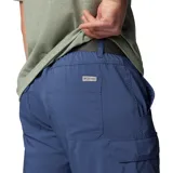 Pantalón convertible de senderismo color azul, diseñado con tecnología de secado rápido y protección solar. Cuenta con bolsillos cargo laterales, bolsillos de seguridad con cremallera y perneras desmontables mediante cremallera que permiten convertir la prenda en un pantalón corto.
