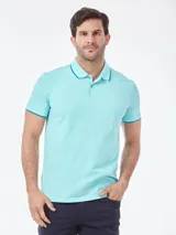 Chomba de piqué de algodón con cuello y puños en contraste, cierre frontal de dos botones y logo bordado sutil en el pecho.