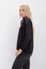 Sweater de calce relajado con diseño jacquard floral y destellos de lurex. Presenta cuello redondo en rib, mangas largas y puños con terminación en punto festón.