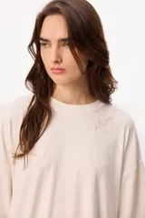 Remera básica de algodón color negro, con cuello redondo y detalle de bordado en el hombro.