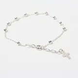 Pulsera de plata 925 tipo rosario, compuesta por una cadena de eslabones finos intercalados con pequeñas esferas metálicas y un dije de cruz colgante en el extremo.