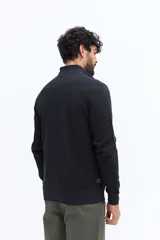 Campera de algodón color beige, estilo deportivo con cierre frontal, cuello alto y puños. Presenta bolsillos laterales y un pequeño logo bordado en el pecho.