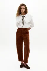 Pantalón de corduroy color caramelo, de corte barrel relajado, tiro medio, cierre frontal y bolsillos laterales y traseros.