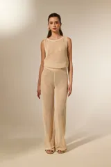 Pantalón largo de tejido en red con lentejuelas, color beige, de tiro bajo y corte holgado.