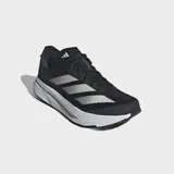 Championes de running Adidas Adizero SL 2, color negro con tres franjas laterales blancas y detalles en gris oscuro en el talón. Cuentan con una suela gruesa de amortiguación blanca.