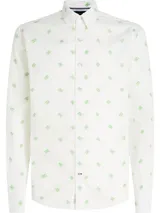 Camisa de corte regular confeccionada en popelín de puro algodón, con cuello de botones y estampado integral del monograma TH en color verde a contraste sobre fondo blanco.