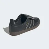 Championes Adidas Samba LT de cuero negro con las tres tiras laterales en blanco y suela de goma color caramelo.