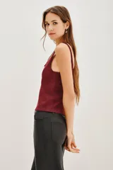 Musculosa de punto con acabado metalizado, escote en V y breteles anchos. Presenta un diseño liso y entallado.
