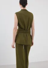 Chaleco de punto fino color verde militar, con diseño recto, cuello perkins, manga corta y detalle de cinturón para atar en la cintura.