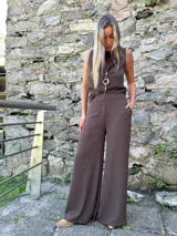 Pantalón de corte oxford y pierna ancha, color chocolate, con pretina frontal lisa, elástico en la parte posterior y bolsillos laterales.