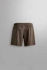 Short deportivo Zara Athleticz color marrón, de tejido técnico ligero y elástico con cintura elástica ajustable con cordón y detalles de bolsillos.