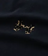 Remera negra de algodón con cuello redondo, mangas cortas abullonadas y apliques flocados con diseño de leopardo.