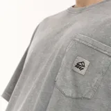Remera verde oliva de corte oversize, con bolsillo en el pecho y logo de la marca.