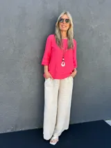 Pantalón palazzo de lino color beige, con cintura elastizada, bolsillos laterales y presillas para cinturón.