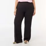 Pantalón de punto gofrado color negro, de corte ancho y relajado con cintura elástica.