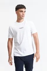 Remera de manga corta color azul marino con cuello redondo y calce regular. Presenta un estampado gráfico en la espalda que incluye un paisaje montañoso al atardecer, el texto 'KINDNESS MATTERS' y el logo de la marca Mistral.