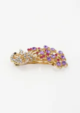 Broche para el pelo dorado con forma de cisne, decorado con strass blancos, violetas y fucsias.