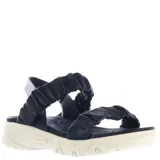 Sandalias de mujer negras con tiras elásticas y plataforma blanca.