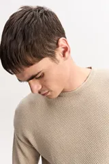 Sweater de punto texturizado color azul marino, de manga larga, con cuello polo en color beige contrastante.