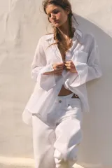 Camisa oversize de cuello solapa, confeccionada en gasa. Presenta manga larga con hombro caído y puños, bolsillo de plastrón en el delantero y cierre frontal con botones.