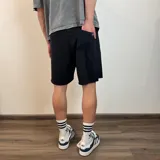 Short de algodón gris melange con cintura elástica y cordón de ajuste, de corte holgado y ruedo sin costura.