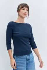 Remera de manga tres cuartos con cuello redondo, confeccionada en tejido de punto liso, con un ajuste entallado al cuerpo.