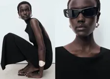 Vestido midi de corte recto y diseño minimalista, confeccionado en tejido elástico. Presenta cuello barco, tirantes anchos, espalda descubierta y una abertura posterior en el bajo.