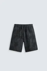 Bermuda de corte relajado, color gris oscuro con efecto tie-dye o textura irregular. Presenta cintura elástica ajustable con cordón y bolsillos laterales y traseros de plastrón.