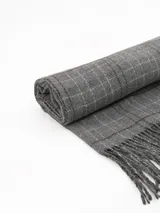 Bufanda tipo pashmina de tejido suave, color gris con diseño de cuadros en tonos oscuros y líneas finas en rosa. Presenta terminaciones con flecos en los extremos.