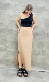 Pollera larga color beige, de corte recto con abertura lateral.