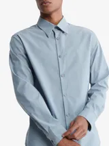 Camisa celeste de manga larga con logo bordado en el pecho.