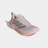 Championes de running Adidas Supernova Glide, con diseño aerodinámico en tonos lila y suela de plataforma en color durazno. Presentan el logo de las tres tiras en acabado metalizado plateado en el lateral y tecnología de amortiguación Dreamstrike glow en la mediasuela.