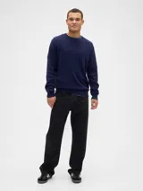 Buzo de punto con textura acanalada vertical, cuello redondo y mangas largas con puños elásticos.