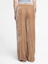 Pantalón negro de terciopelo, corte recto y relajado, con pretina elastizada con cordón ajustable y bolsillos laterales.