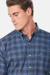 Camisa de manga larga confeccionada en viyela de algodón, con diseño de cuadros en tonos azules y negros. Presenta cuello abotonado, cierre frontal con botones y logo bordado en el pecho.