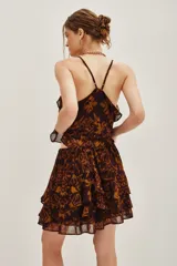 Falda corta con volados, confeccionada en tela estampada con diseño abstracto en tonos marrones y ocres.