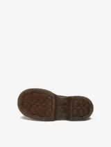 Zapato de cuero marrón con suela gruesa y redondeada, inspirado en modelos de los años 90. Presenta 5 ojales, pespuntes blancos y amarillos, cuello acolchado y cordones tonales.