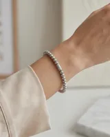 Pulsera esclava de acero compuesta por pequeñas esferas texturizadas con un diseño estriado.