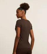 Remera deportiva marrón de microfibra texturizada, con cuello redondo, mangas cortas y estampado frontal con el texto "Sunday Coffee Dept.".