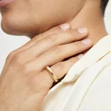 Anillo de aleación de metales bañado en oro de 18k, con forma redondeada y superficie lisa.