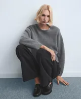 Pantalón de jean negro de corte recto y tiro alto, con diseño clásico de cinco bolsillos y cierre frontal con botón y cremallera.