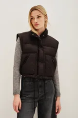 Campera puffer color tostado, con cierre frontal y botones a presión, cuello alto y puños tejidos acanalados.