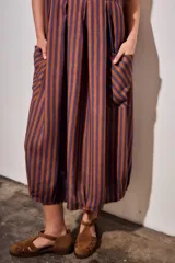 Vestido midi sin mangas, con diseño a rayas en tonos marrón y azul, cuello redondo y bolsillos laterales amplios.