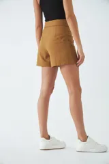 Short de vestir tiro alto con diseño de solapa en la cintura, corte recto y cierre frontal con cremallera y botón.