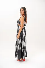 Vestido largo de satén con estampado abstracto en blanco y negro, escote en V, aberturas cut-out en la cintura y aberturas laterales en la falda.