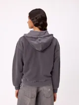 Canguro con cierre frontal y capucha, color gris con efecto desgastado. Presenta bolsillos laterales y logo bordado en el pecho.