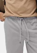 Bermuda de corte recto en color negro, confeccionada en tejido de algodón, con cierre frontal y bolsillos laterales.