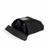 Botinera Adidas modelo Tiro, color negro con las icónicas tres tiras y logo de la marca en blanco. Cuenta con un diseño compacto, cierre seguro y base reforzada con perforaciones para ventilación.