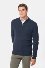 Buzo tejido de punto azul marino con textura estructurada, cuello alto y cierre frontal parcial con tirador de cuero.
